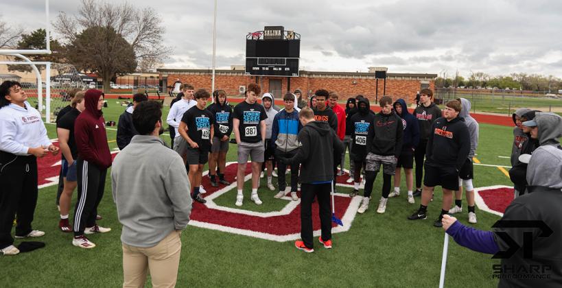 Athletes receive instruction on how to complete the standing broad jump test at last Saturday's Sharp Performance Combine. (Photo by Rayne Schmidtberger)