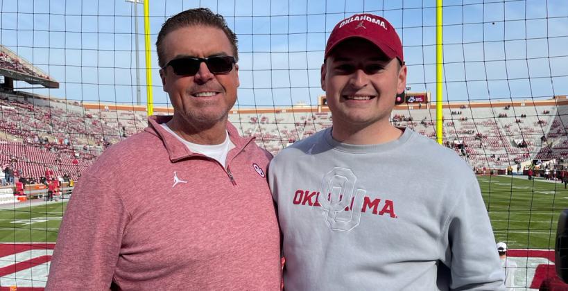 Cutline: John Kelly (right) stands with his father, Jim, at the University of Oklahoma's football stadium. (Courtesy Photo)