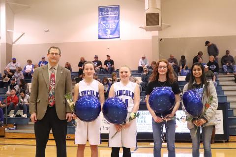 The Lincoln girls cross country team was honored for their 1A Cross Country Championship during Tuesday night's basketball games. Left-to-right: Coach Steve Crist, freshman Raegan Stewart, sophomore Jaycee Vath, freshman Shelbie Ford and senior Aubry Donley. (Photo courtesy Kae Hayworth)