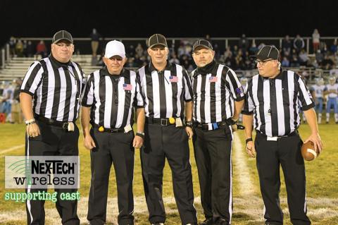 Veteran official Terrell Olson is flanked by the rest of his crew, including sons Travis and Troy, at his final game before retiring after a decades long career officiating high school sporting events in Kansas. (Photo by Karen Schroeder Photography)